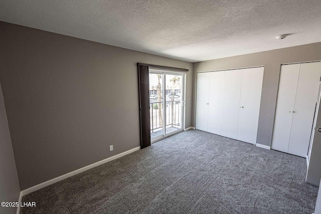 276 Lake Havasu Ave S Unit C31, Lake Havasu City, AZ 86403 - unfurnished bedroom with access to outside, carpet flooring, a textured ceiling, multiple closets, and a textured wall