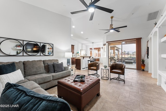 living area featuring visible vents, recessed lighting, and lofted ceiling