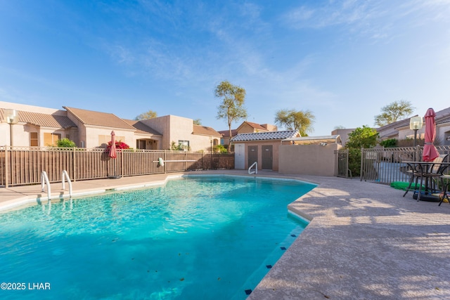 view of swimming pool with a fenced in pool, a residential view, a patio, and fence