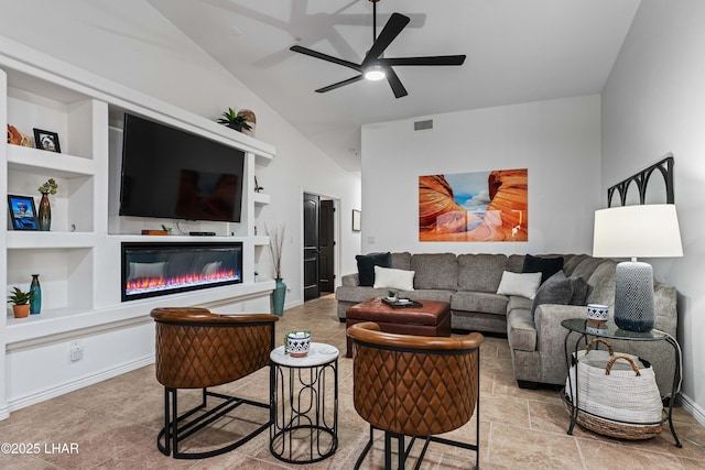 living room with built in features, visible vents, lofted ceiling, ceiling fan, and a glass covered fireplace