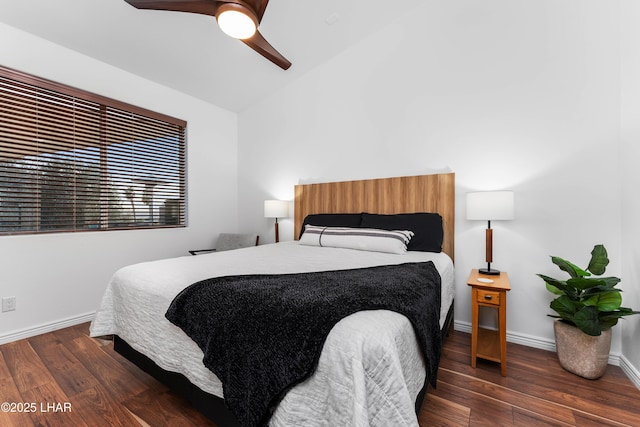 bedroom with wood finished floors, a ceiling fan, baseboards, and vaulted ceiling