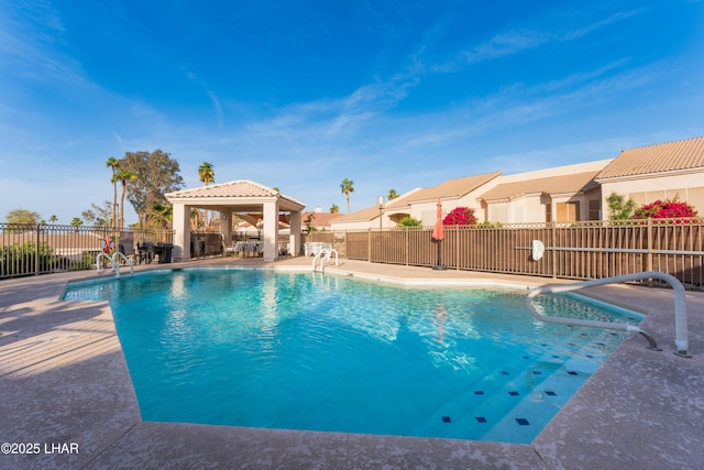 view of swimming pool with a gazebo, a patio area, a fenced in pool, and fence