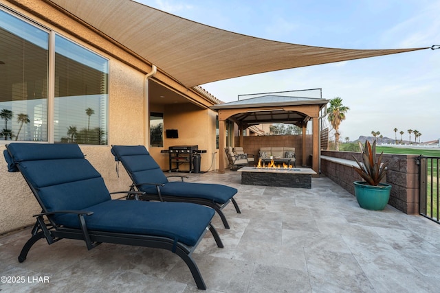 view of patio / terrace with a gazebo, an outdoor fire pit, and fence