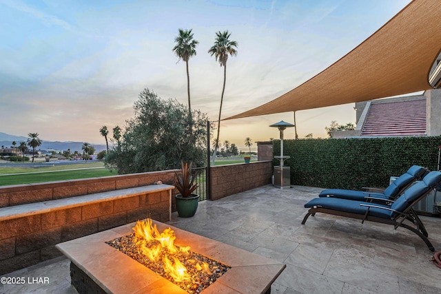 view of patio featuring fence and an outdoor fire pit