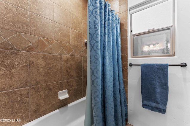 bathroom featuring shower / bathtub combination with curtain