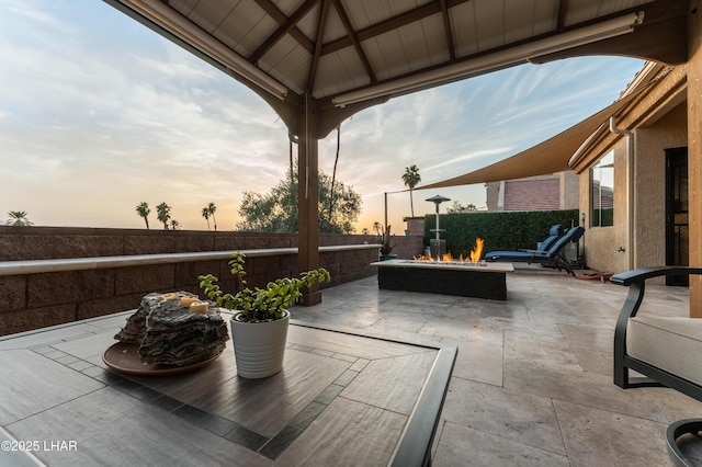 view of patio featuring a gazebo, a fire pit, and fence