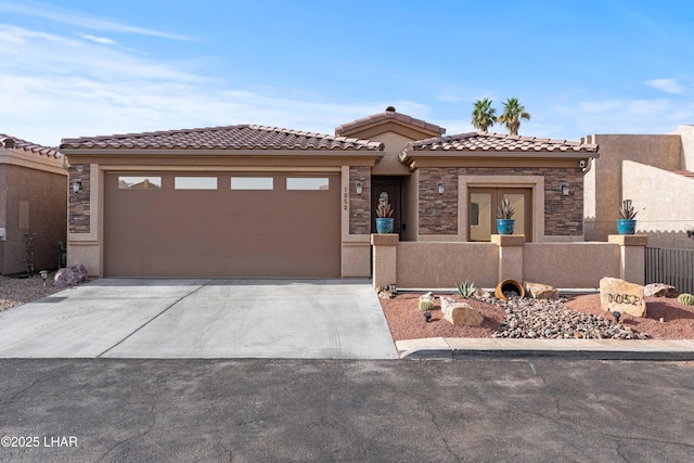 view of front of home featuring an attached garage, a fenced front yard, stucco siding, stone siding, and driveway