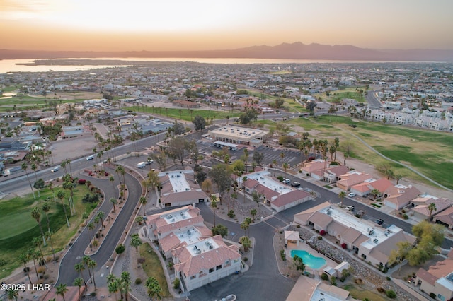 aerial view at dusk featuring a residential view