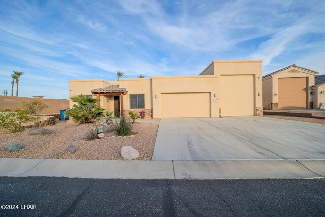 southwest-style home featuring a garage