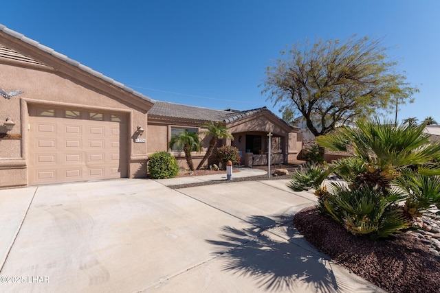 ranch-style home featuring stucco siding, concrete driveway, an attached garage, and a tiled roof