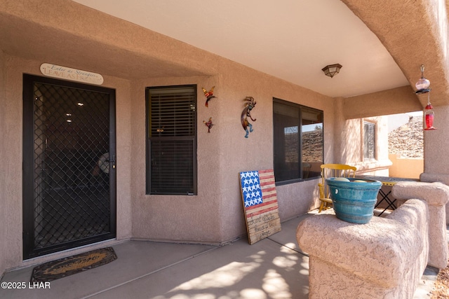 property entrance with stucco siding