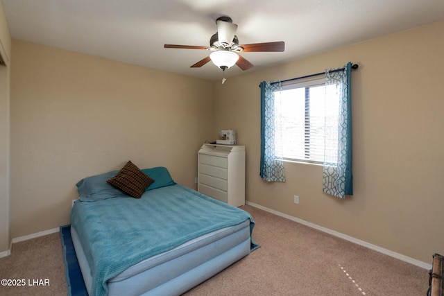 bedroom with a ceiling fan, baseboards, and carpet floors