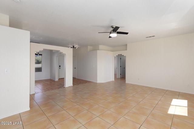 spare room featuring visible vents, baseboards, and ceiling fan