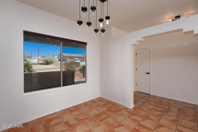 spare room featuring baseboards
