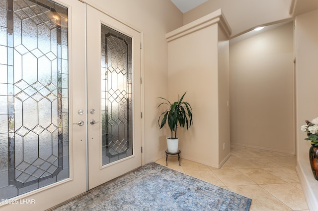 foyer entrance with light tile patterned floors