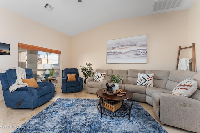 living room with lofted ceiling and light tile patterned flooring