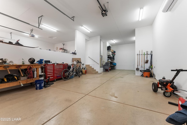 garage featuring a garage door opener, a workshop area, and an AC wall unit