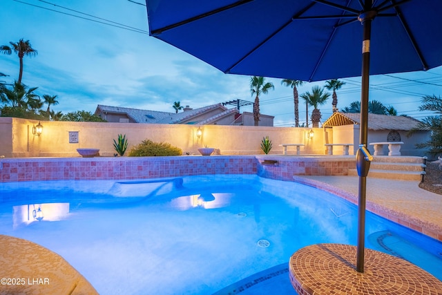 view of pool at dusk