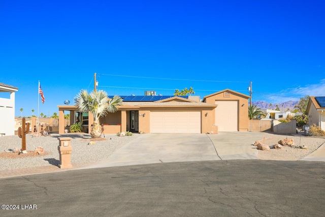 view of front of home with a garage and solar panels