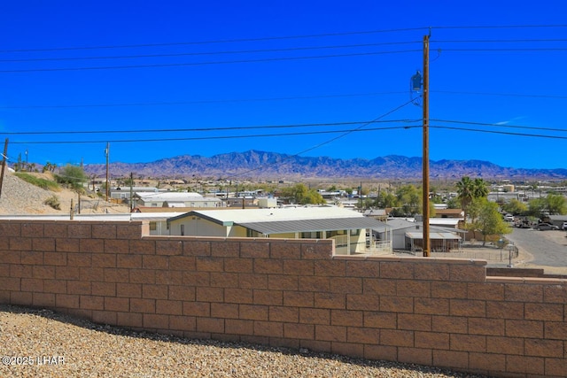 view of yard featuring fence and a mountain view