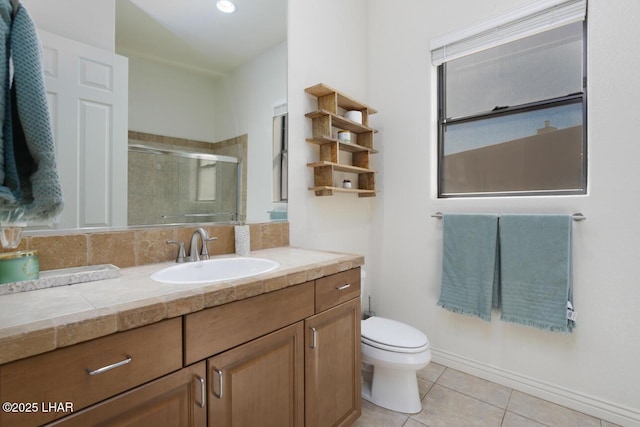 full bath with a stall shower, vanity, toilet, and tile patterned floors