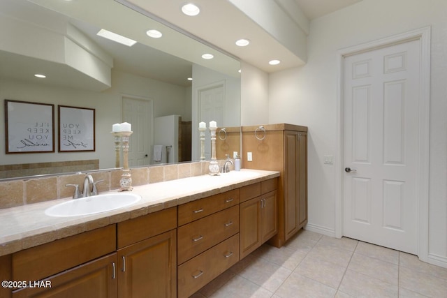 bathroom with double vanity, recessed lighting, a sink, and tile patterned floors