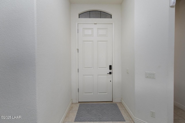 entryway featuring light tile patterned flooring and baseboards