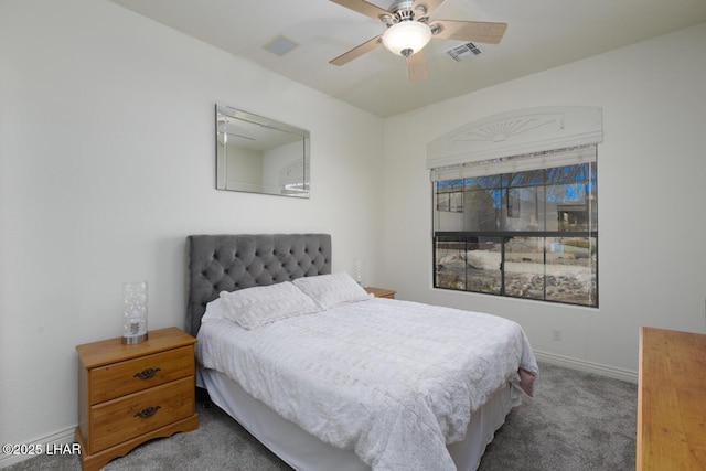 carpeted bedroom with a ceiling fan, visible vents, and baseboards