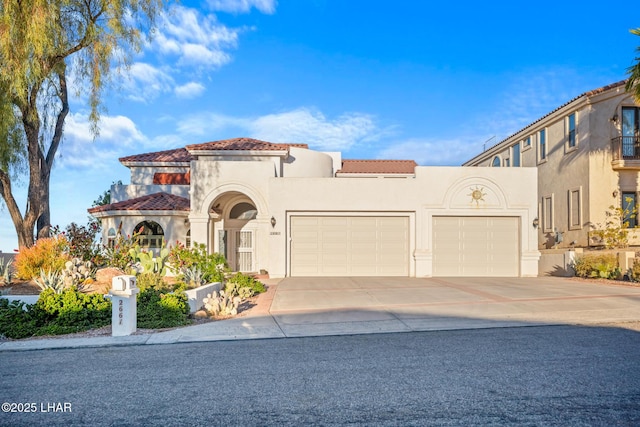 mediterranean / spanish home with a garage