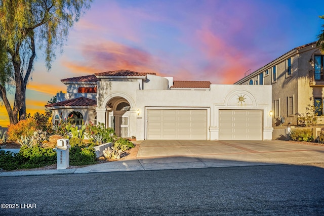 mediterranean / spanish home with a garage