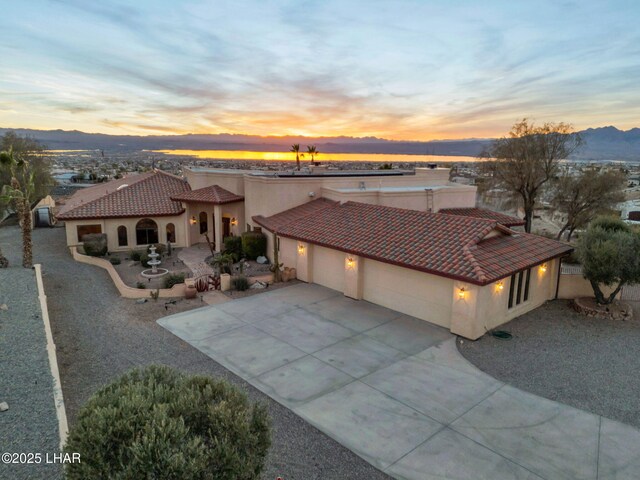 view of front facade with a garage and a mountain view