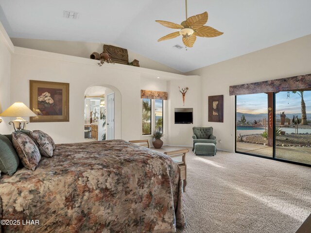 carpeted bedroom featuring multiple windows, access to exterior, vaulted ceiling, and ceiling fan