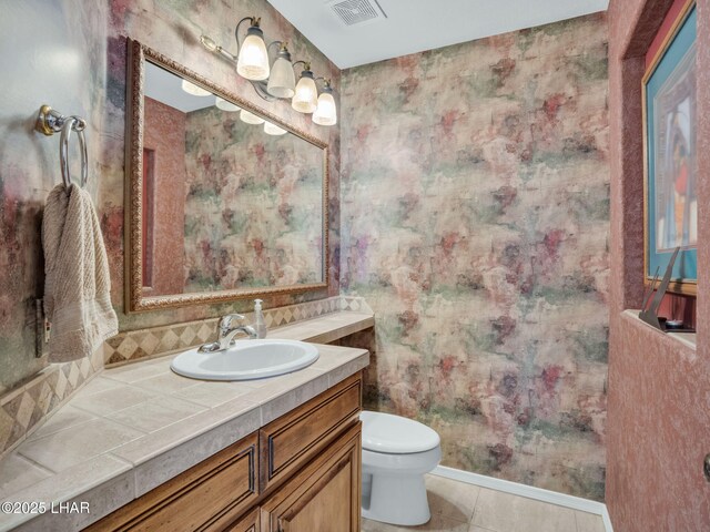 bathroom with vanity, tile patterned floors, and toilet