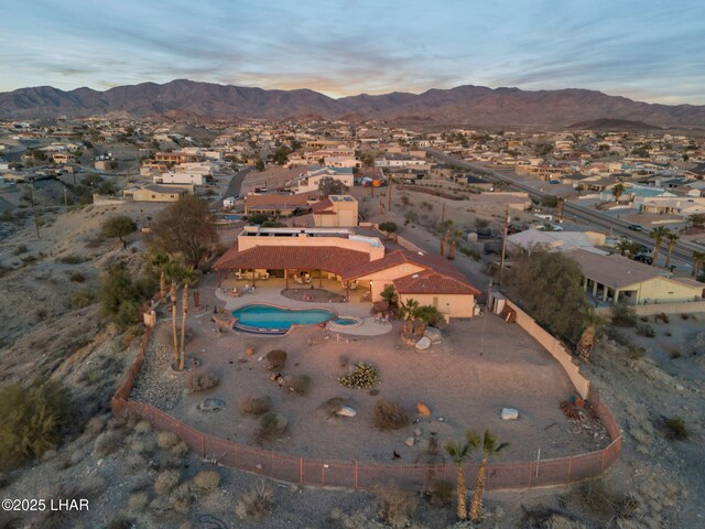 aerial view at dusk featuring a mountain view