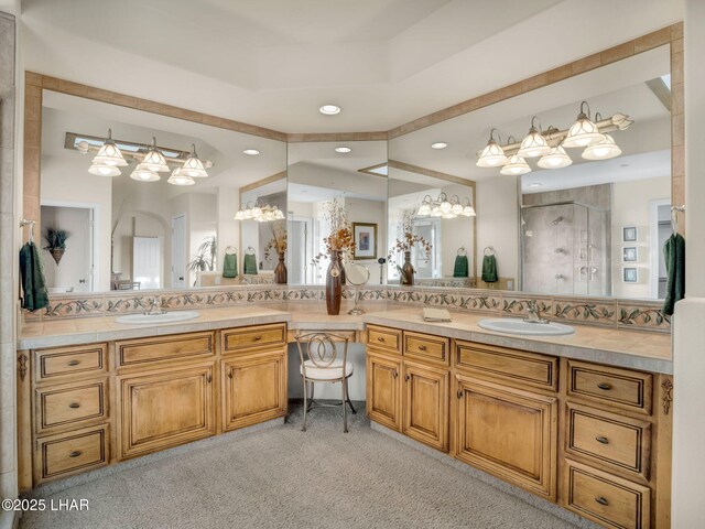 bathroom featuring walk in shower, vanity, and decorative backsplash