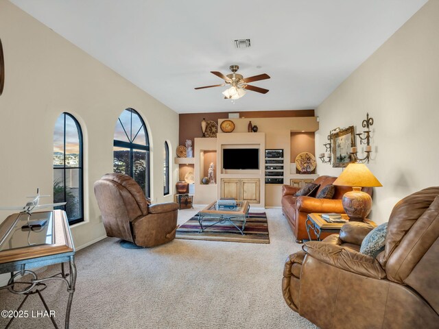 living room featuring ceiling fan and carpet