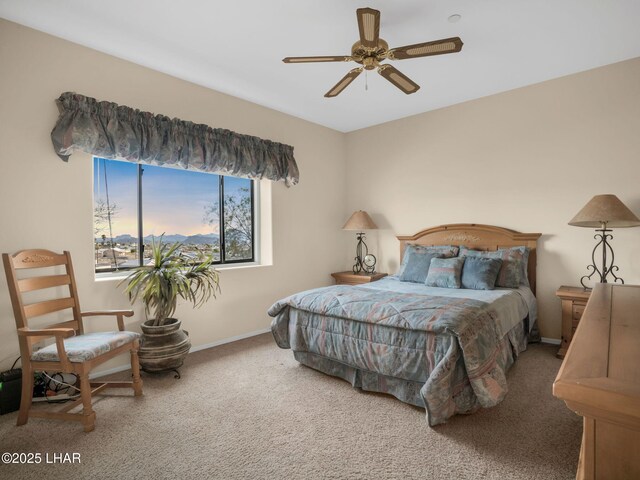 bedroom featuring ceiling fan and carpet