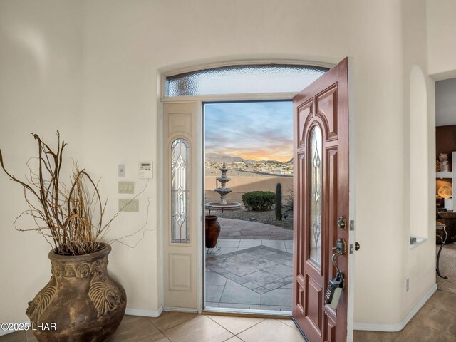 foyer entrance with light tile patterned floors