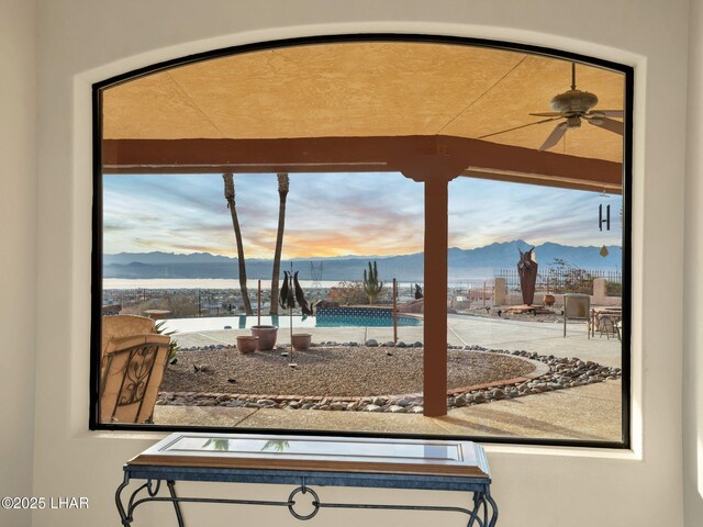 interior space featuring ceiling fan, a mountain view, and a wealth of natural light