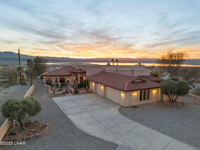 view of front of property with a garage and a mountain view