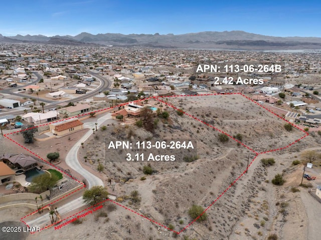 birds eye view of property featuring a mountain view