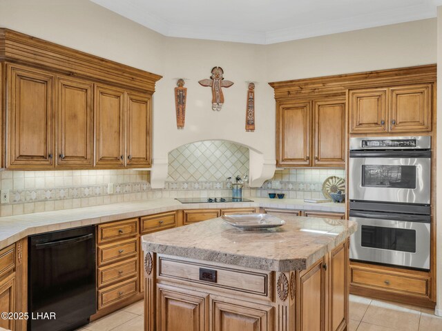 kitchen featuring a kitchen island, ornamental molding, black appliances, light tile patterned flooring, and decorative backsplash