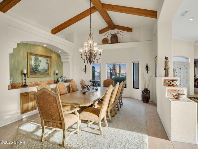 dining space featuring an inviting chandelier, light tile patterned floors, beam ceiling, and high vaulted ceiling