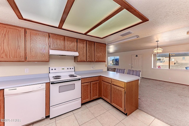 kitchen with white appliances, a healthy amount of sunlight, kitchen peninsula, and hanging light fixtures