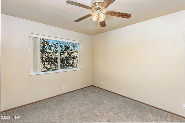 carpeted spare room with ceiling fan and a textured ceiling