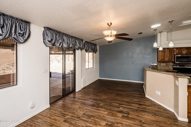 kitchen with stone counters, ceiling fan, dark hardwood / wood-style floors, and a textured ceiling