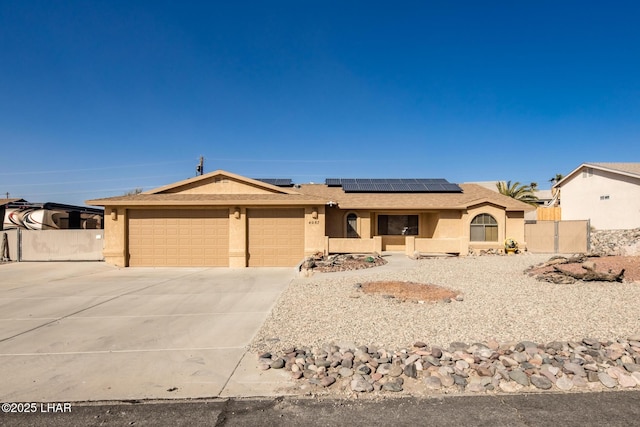 single story home featuring a garage and solar panels