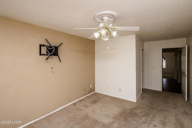 carpeted empty room with ceiling fan and a textured ceiling