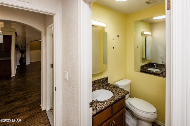 bathroom featuring vanity, toilet, and wood-type flooring