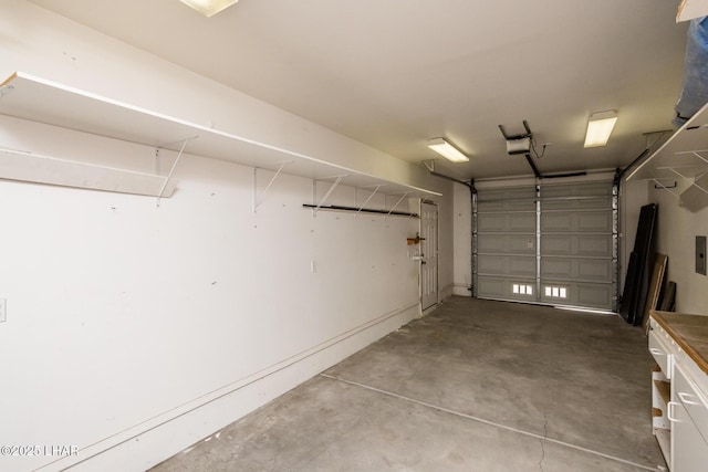 garage with a garage door opener and electric panel